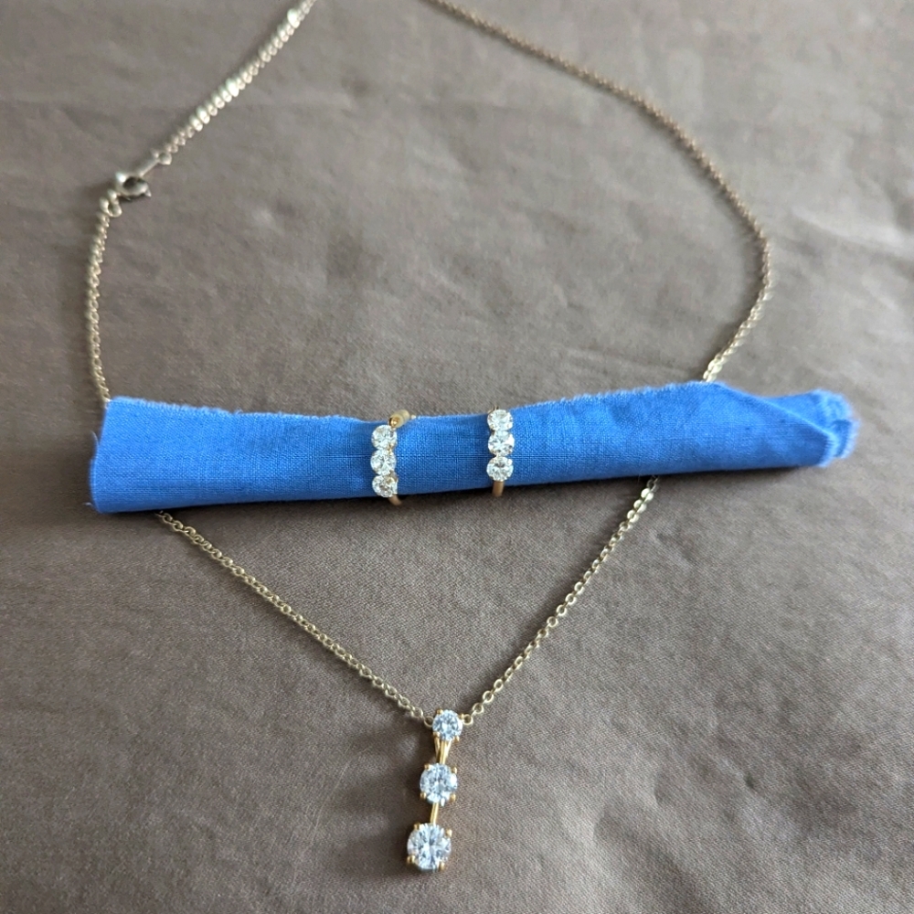 Pair of earrings with three stone pendant on short gold colored chain